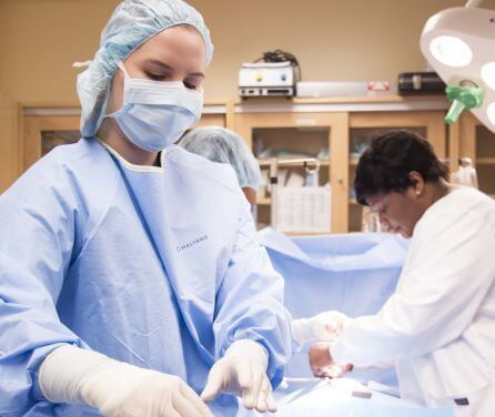 A student in PPE works with healthcare tools