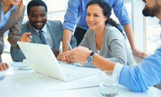 People gathered around a laptop