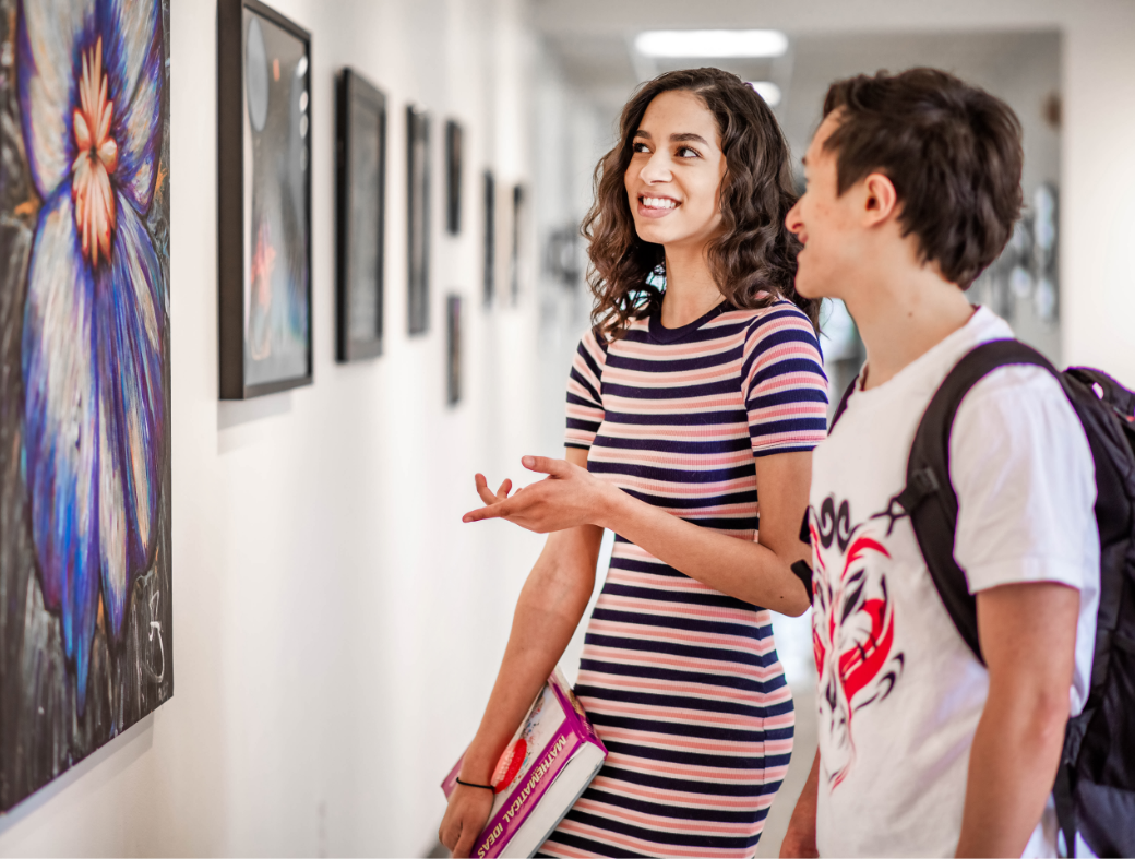 Students in hallway viewing art